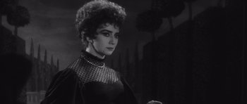 Movie still from “Last Year at Marienbad” (1961), directed by Alain Resnais – A black and white photo of a woman in a black dress; Close Up shot, Low angle