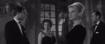 Movie still from “Last Year at Marienbad” (1961), directed by Alain Resnais – A black and white photo of two women; Close Up shot, Over the shoulder angle