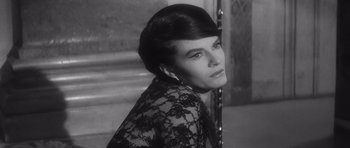 Movie still from “Last Year at Marienbad” (1961), directed by Alain Resnais – A black and white photo of a woman in a lace dress; Close Up shot, High angle