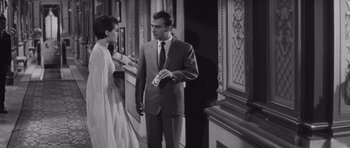 Movie still from “Last Year at Marienbad” (1961), directed by Alain Resnais – A black and white photo of a man and a woman; Medium shot, Low angle