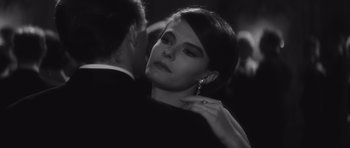 Movie still from “Last Year at Marienbad” (1961), directed by Alain Resnais – A man and a woman in black and white; Close Up shot, Over the shoulder angle