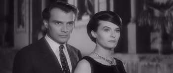 Movie still from “Last Year at Marienbad” (1961), directed by Alain Resnais – A man and a woman standing next to each other; Close Up shot, Low angle