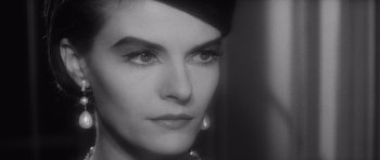 Movie still from “Last Year at Marienbad” (1961), directed by Alain Resnais – A woman's face in black and white; Close Up shot, Over the shoulder angle