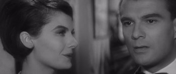 Movie still from “Last Year at Marienbad” (1961), directed by Alain Resnais – A man and a woman looking at one another; Close Up shot, Over the shoulder angle