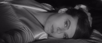 Movie still from “Last Year at Marienbad” (1961), directed by Alain Resnais – A person laying on the ground; Close Up shot, High angle