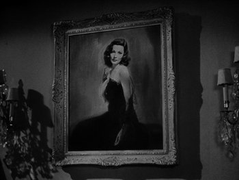 Movie still from “Laura” (1944), directed by Rouben Mamoulian – A black and white photo of a woman in a dress; Close Up shot, Low angle