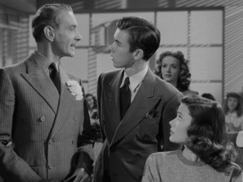 Movie still from “Laura” (1944), directed by Rouben Mamoulian – A group of people standing next to each other in a room; Medium shot, Low angle