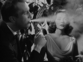 Movie still from “Laura” (1944), directed by Rouben Mamoulian – A black and white photo of a man and a woman; Close Up shot, Low angle