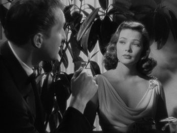 Movie still from “Laura” (1944), directed by Rouben Mamoulian – A man and a woman are looking at each other; Close Up shot, Over the shoulder angle