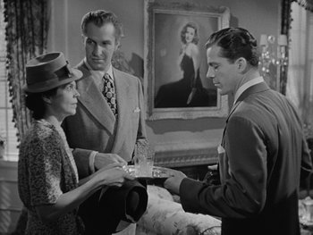 Movie still from “Laura” (1944), directed by Rouben Mamoulian – A man and a woman serving a man a tray of food; Medium shot, Over the shoulder angle