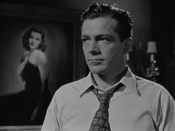 Movie still from “Laura” (1944), directed by Rouben Mamoulian – Black and white photograph of a man wearing a neck tie; Close Up shot, Low angle