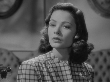 Movie still from “Laura” (1944), directed by Rouben Mamoulian – A black - and - white photo of a woman in a checkered shirt; Close Up shot, Low angle
