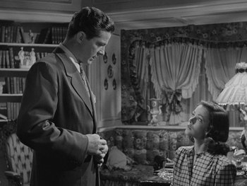 Movie still from “Laura” (1944), directed by Rouben Mamoulian – A man and a woman in a living room talking to each other; Medium shot, Low angle