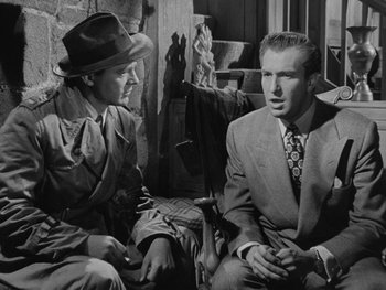 Movie still from “Laura” (1944), directed by Rouben Mamoulian – Two men sitting next to each other in a room; Medium shot, Over the shoulder angle