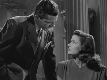 Movie still from “Laura” (1944), directed by Rouben Mamoulian – A man and a woman are talking to each other; Medium shot, Over the shoulder angle