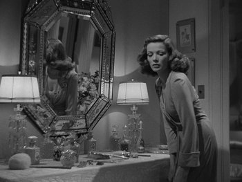 Movie still from “Laura” (1944), directed by Rouben Mamoulian – A black and white photo of a woman in front of a mirror; Medium shot, Low angle