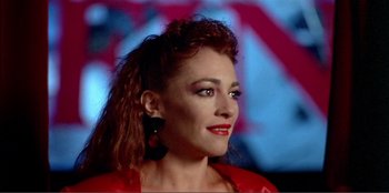 Movie still from “Law of Desire” (1987), directed by Pedro Almodóvar – A person wearing a red shirt; Close Up shot, Over the shoulder angle