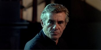 Movie still from “Law of Desire” (1987), directed by Pedro Almodóvar – A person wearing a black shirt; Close Up shot, Low angle