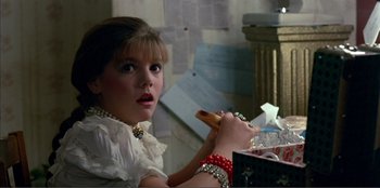 Movie still from “Law of Desire” (1987), directed by Pedro Almodóvar – A young girl holding a hot dog in her hand; Close Up shot, Over the shoulder angle