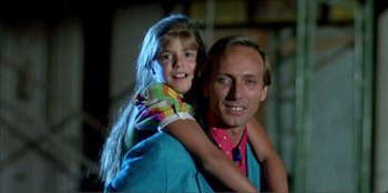 Movie still from “Law of Desire” (1987), directed by Pedro Almodóvar – A man and a little girl posing for a picture; Close Up shot, Low angle