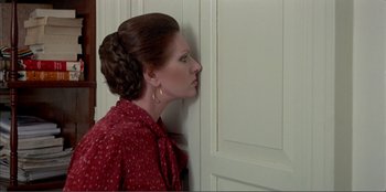 Movie still from “Law of Desire” (1987), directed by Pedro Almodóvar – A woman in a red dress leaning against a wall; Close Up shot, Over the shoulder angle