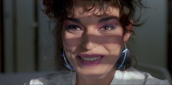 Movie still from “Law of Desire” (1987), directed by Pedro Almodóvar – A person wearing a white shirt; Close Up shot, Overhead angle