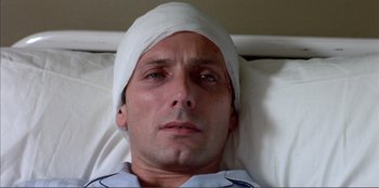 Movie still from “Law of Desire” (1987), directed by Pedro Almodóvar – A person wearing a head band; Close Up shot, Overhead angle