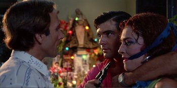 Movie still from “Law of Desire” (1987), directed by Pedro Almodóvar – A group of people standing next to each other in a room; Close Up shot, Low angle