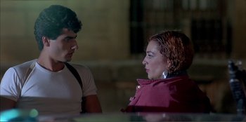 Movie still from “Law of Desire” (1987), directed by Pedro Almodóvar – A man and a woman talking to each other; Close Up shot, Over the shoulder angle