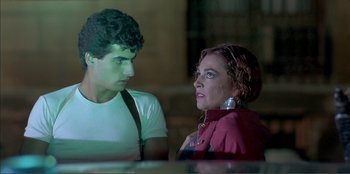 Movie still from “Law of Desire” (1987), directed by Pedro Almodóvar – A man and a woman are talking to each other; Close Up shot, Low angle