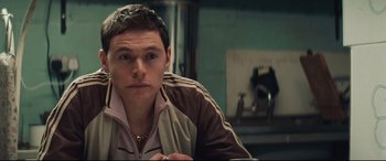 Movie still from “Layer Cake” (2004), directed by Matthew Vaughn – A person sitting in a room; Close Up shot, Over the shoulder angle