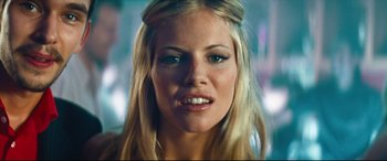 Movie still from “Layer Cake” (2004), directed by Matthew Vaughn – A person with long blonde hair; Close Up shot, Low angle