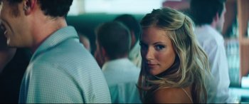 Movie still from “Layer Cake” (2004), directed by Matthew Vaughn – A beautiful young blonde woman posing for a picture; Close Up shot, Low angle