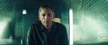 Movie still from “Layer Cake” (2004), directed by Matthew Vaughn – A person wearing a jacket; Close Up shot, Over the shoulder angle