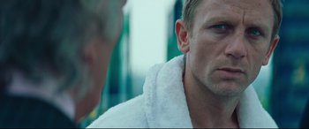 Movie still from “Layer Cake” (2004), directed by Matthew Vaughn – A person wearing a white robe; Close Up shot, Over the shoulder angle