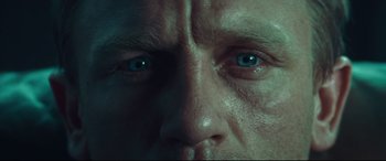 Movie still from “Layer Cake” (2004), directed by Matthew Vaughn – A man's face with blue eyes; Extreme Close Up shot, Overhead angle