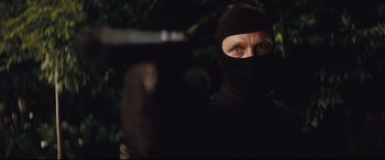 Movie still from “Layer Cake” (2004), directed by Matthew Vaughn – A man wearing a black mask and a black balaclava; Close Up shot, Low angle