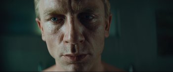 Movie still from “Layer Cake” (2004), directed by Matthew Vaughn – A man's face in a mirror; Close Up shot, Low angle