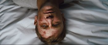 Movie still from “Layer Cake” (2004), directed by Matthew Vaughn – A person laying on a bed; Close Up shot, Overhead angle