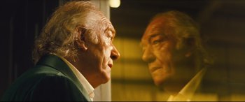 Movie still from “Layer Cake” (2004), directed by Matthew Vaughn – An older man looking at himself in the mirror; Close Up shot, Low angle