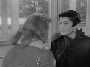 Movie still from “The Girlfriends” (1955), directed by Michelangelo Antonioni – Two women talking to each other in front of a window; Close Up shot, Over the shoulder angle