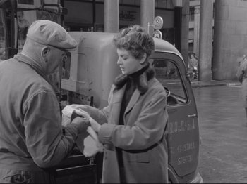 Movie still from “The Girlfriends” (1955), directed by Michelangelo Antonioni – An old photo of a man and a woman in front of an old truck; Medium shot, Low angle