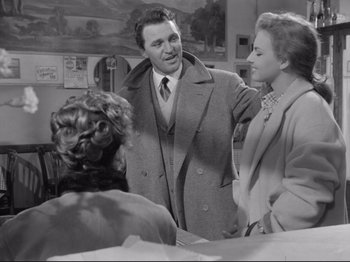 Movie still from “The Girlfriends” (1955), directed by Michelangelo Antonioni – A man and a woman talking to each other; Medium shot, Over the shoulder angle