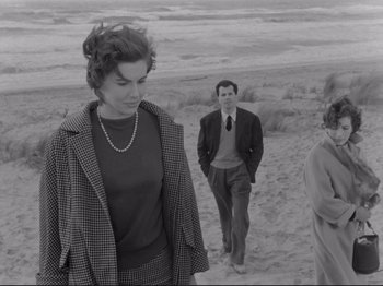 Movie still from “The Girlfriends” (1955), directed by Michelangelo Antonioni – A man and a woman walking on the beach; Medium shot, Over the shoulder angle