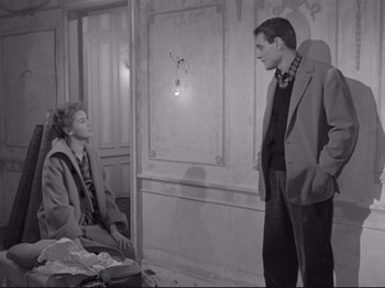 Movie still from “The Girlfriends” (1955), directed by Michelangelo Antonioni – A man and a woman standing next to each other in a room; Medium shot, High angle