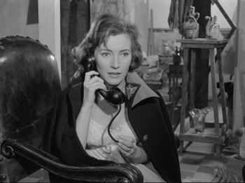 Movie still from “The Girlfriends” (1955), directed by Michelangelo Antonioni – A woman sitting in a chair talking on a phone; Medium shot, High angle