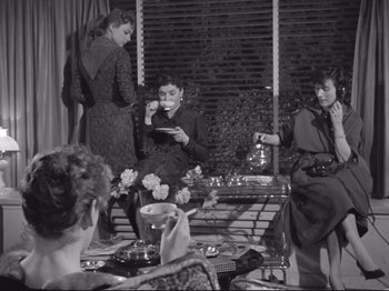 Movie still from “The Girlfriends” (1955), directed by Michelangelo Antonioni – A group of women sitting around a table eating food; Wide shot, High angle