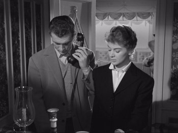 Movie still from “The Girlfriends” (1955), directed by Michelangelo Antonioni – A man and a woman standing next to each other in a room; Medium shot, Low angle