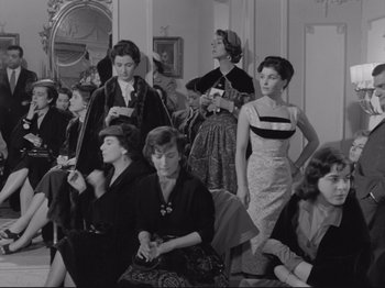 Movie still from “The Girlfriends” (1955), directed by Michelangelo Antonioni – A black and white photo of a group of women sitting in a living room; Medium shot, Low angle