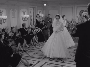 Movie still from “The Girlfriends” (1955), directed by Michelangelo Antonioni – A black and white photo of a group of people in a room; Wide shot, High angle